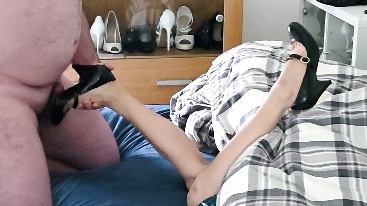 Two legs sticking out from under a blanket in those black patent heels in 36