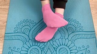 フィットネスの女の子は靴下のマットの上でエクササイズを行い、彼女の足に精液で彼女のトレーナーに足コキを与えます