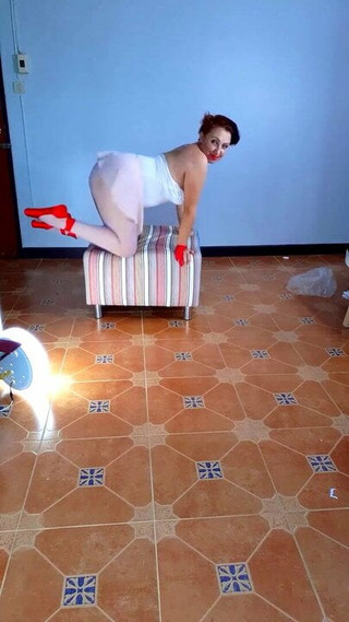 The ballerina takes off her clothes. The undressed ballerina