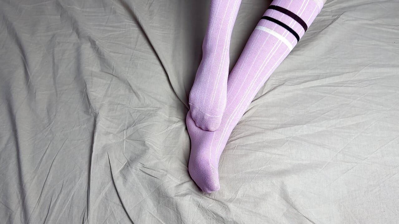 Pink socks in hands of mistress with blue nails in solo video