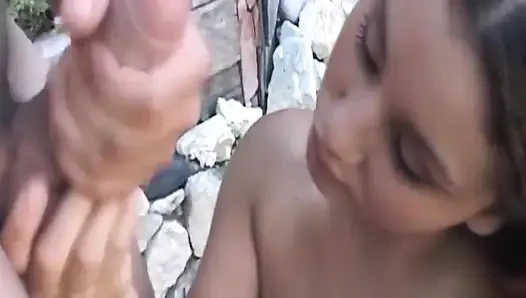 Reife brünette MILf lutscht massiven schwanz im freien