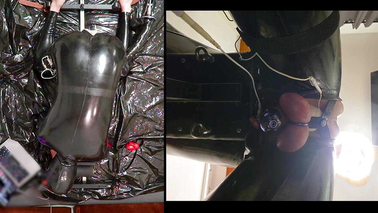 Session in the pillory with Latex Catsuit, PA Chastity, Giant Didildo and Estim