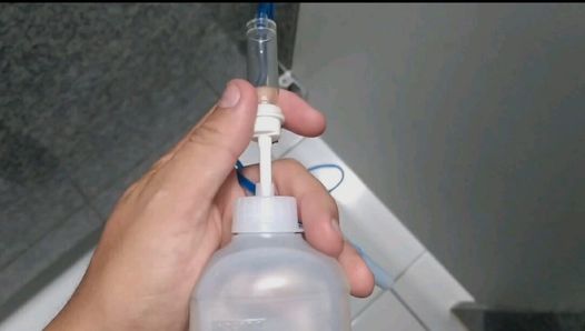 Applying the right liquid serum to the boy's cock.