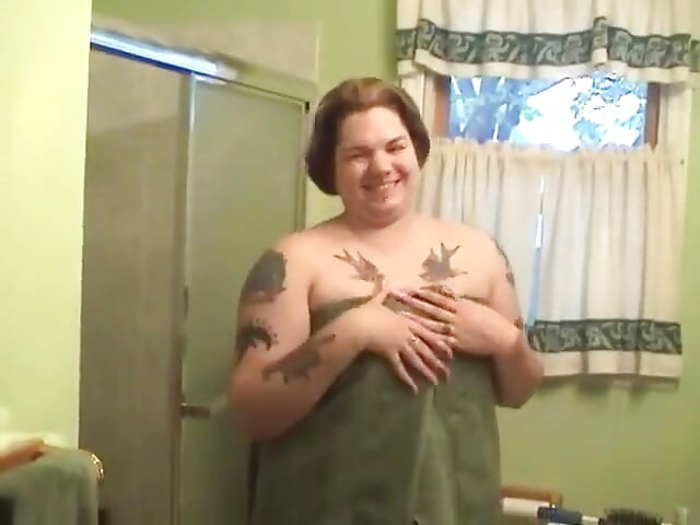 Tattooed fat chick strips to wash her tits and cunt in the shower