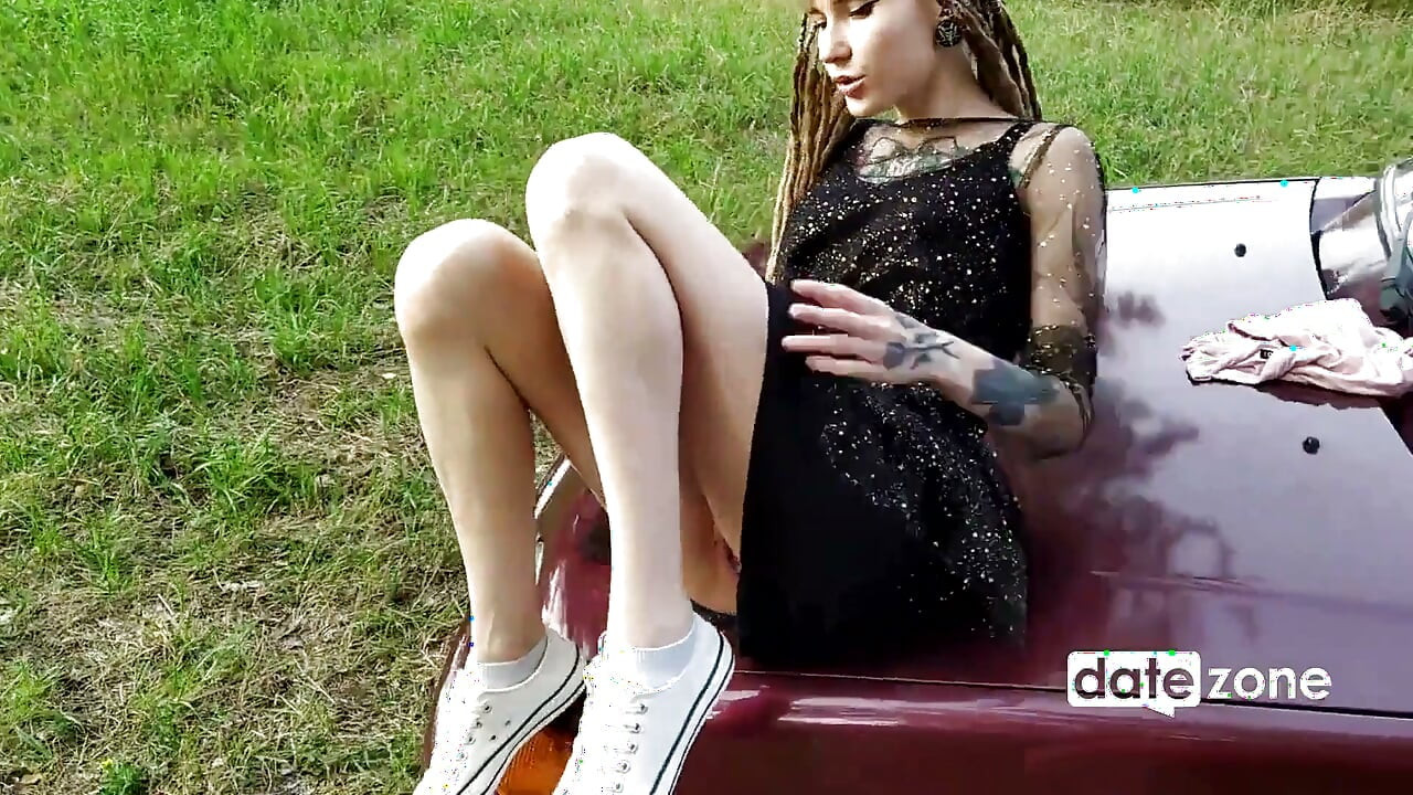 Rebellious Girl with Tattoos and Dreadlocks Fucks with a Dildo Next to the Car