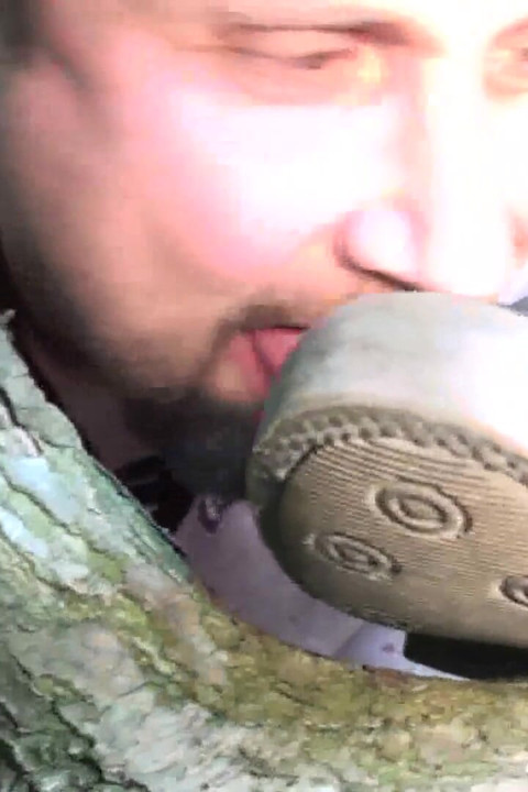 Slave licks clean dirty shoes