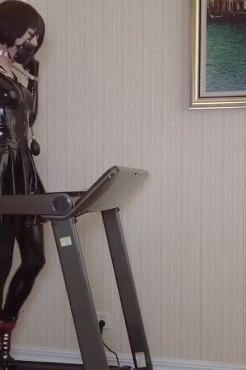 Mz24 - a Girl Bound to a Treadmill with Metal Restraints and Shackles