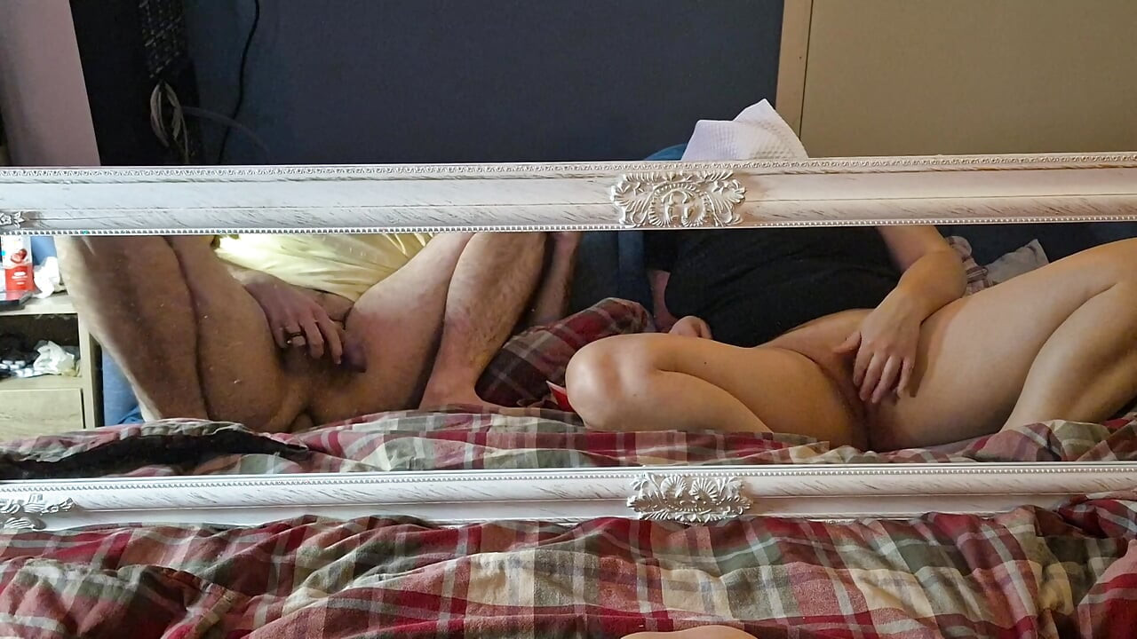 Masturbating together in front of mirror