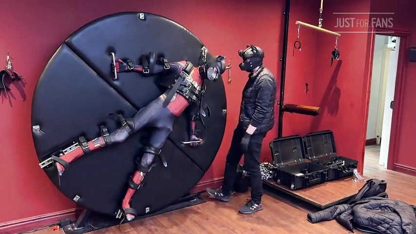 Pup Twink Dressed as Spider-man Strapped to the Bondage Wheel and Milked