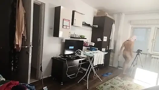 Sexy brunette doing naked chores around the house.