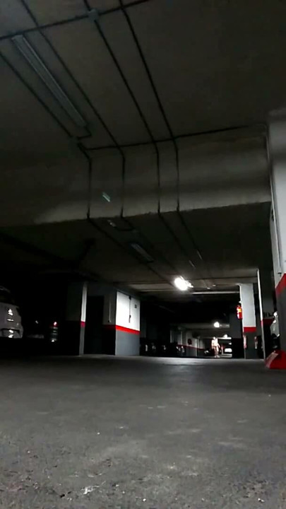 Naked in an underground parking lot