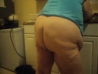 in the kitchen doing dishes