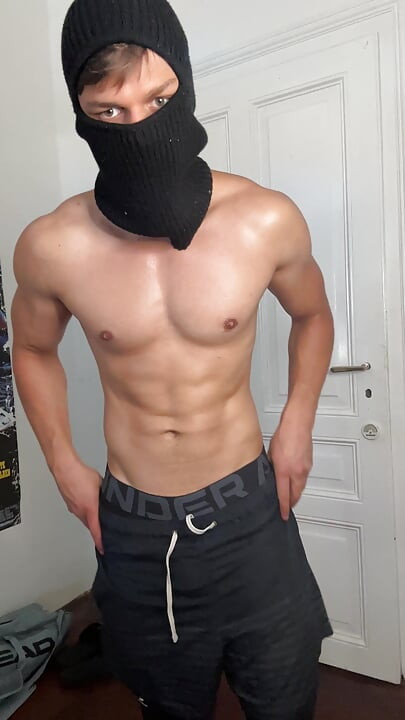 Masked hunk showing off his muscles