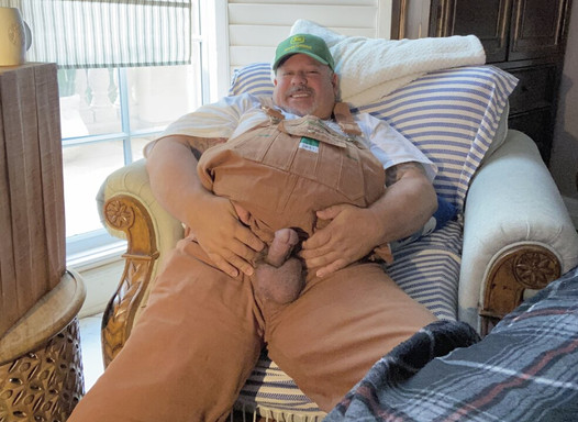 Bib overalls on farmer grandpa with wide feet has hands-free across the room