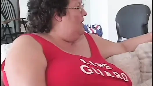 Fat bellied chick in red uniform rides one long stick