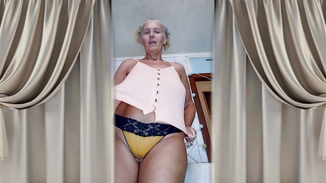 Cheerful old lady Lukerya. Alluring movements and shiny feet on the washing machine.