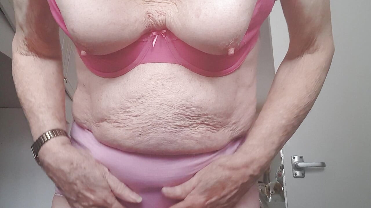 Undressing on a bed..bra and knickers