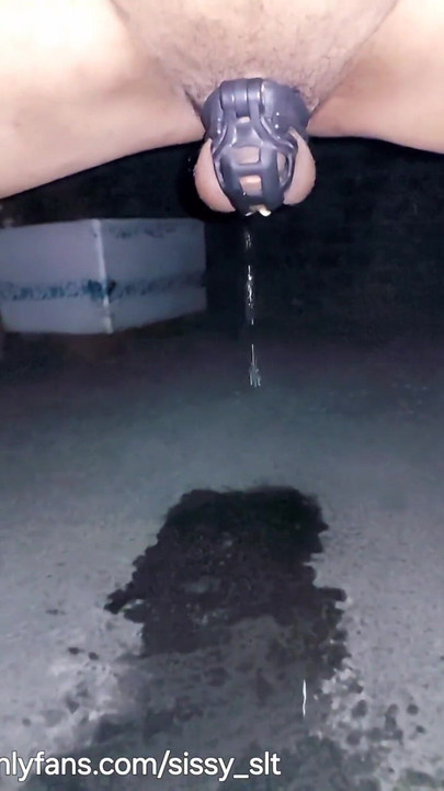 Key moment from "Ladyboy in heels going outdoor and piss while walking in her favorite chastity cage"