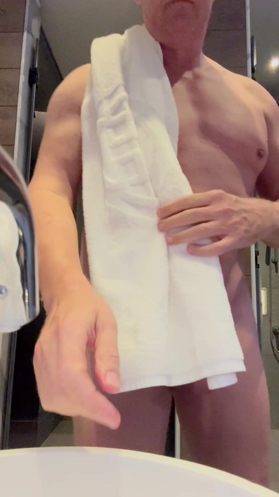 Naked body gets dried after shower