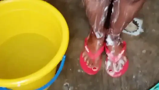Getting a bath in traditional bathroom in village.