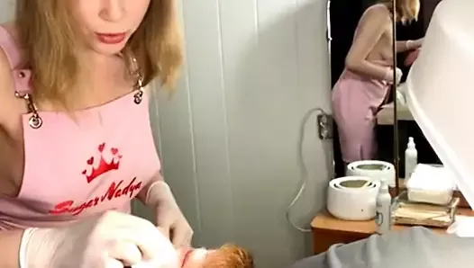 Classy blonde waxes a man's face, her gorgeous breasts popping