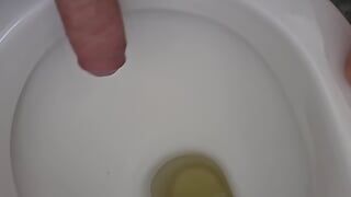 Public toilet pissing and rubbing cock in toilet