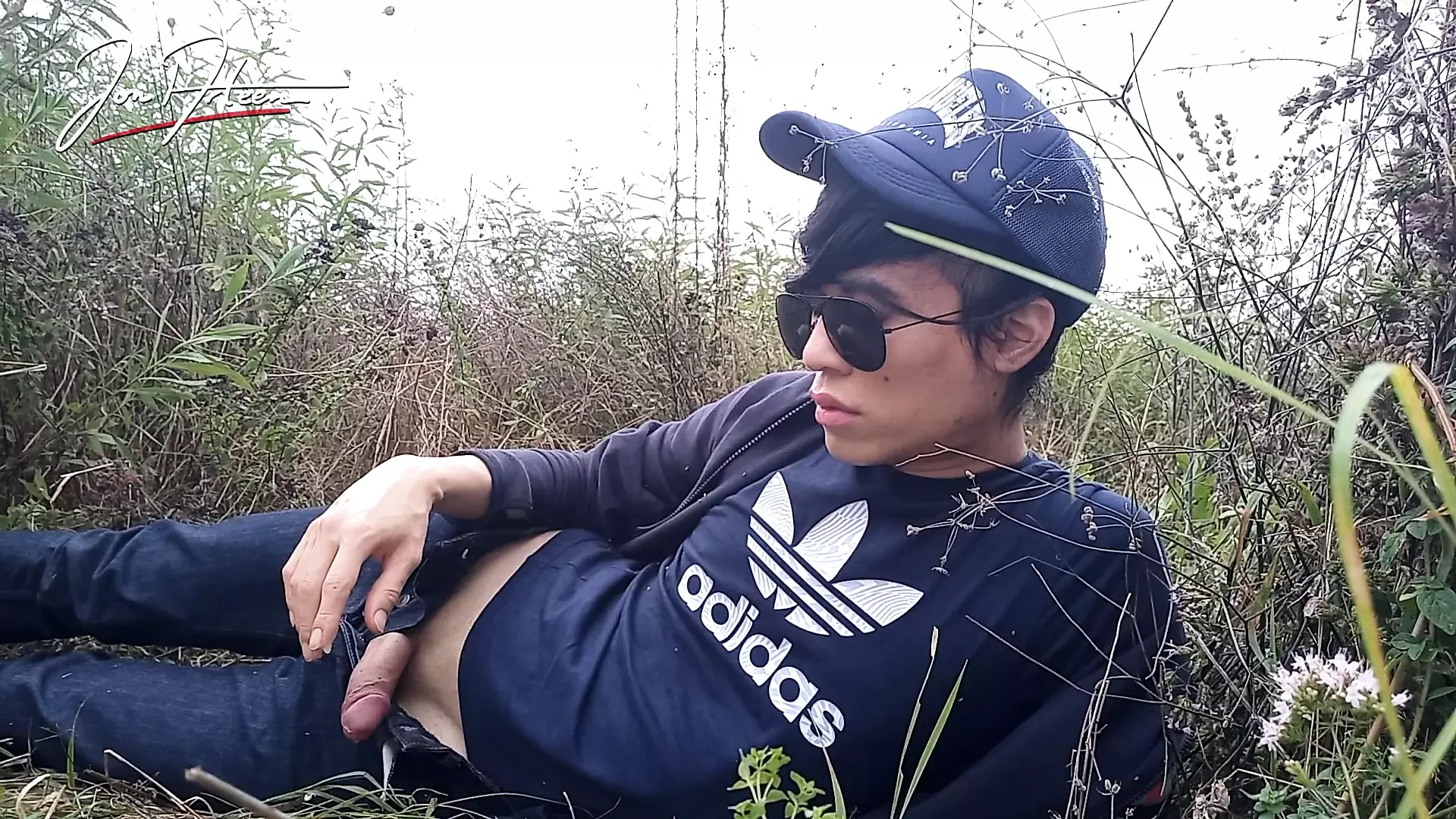 Cute gay Asian twink Jon Arteen speaks French wanks his smooth penis in the rain, lubricated with his saliva moans ejaculates
