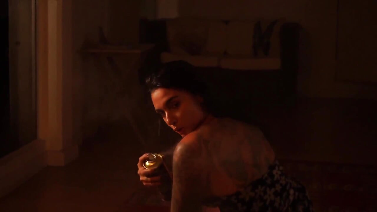 Sensual Latina Doing a Striptease in Low Light