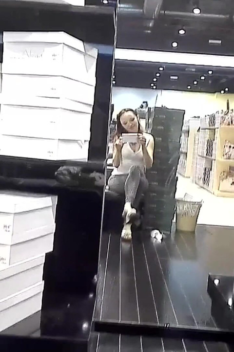 Shoeplay and Dangling in Cute White Flip Flops in a Store