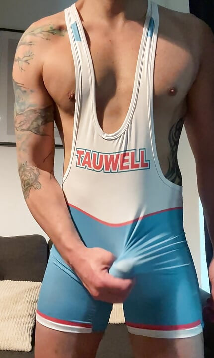 Smooth jock in wrestling singlet jerks off and cums