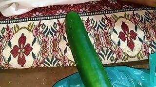 Aunty drains the water from the cucumber while relishing the cucumber to the fullest.