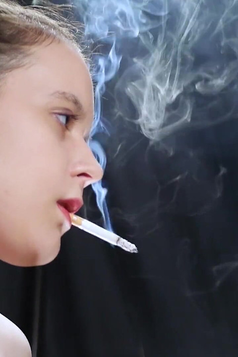 Topless Brunette Smoking in Dramatic Smoke