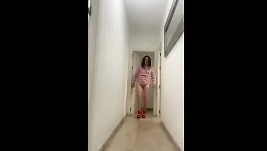 Hot Spanish trans girl walks down the hallway showing her ass in high red heels with a pretty dress