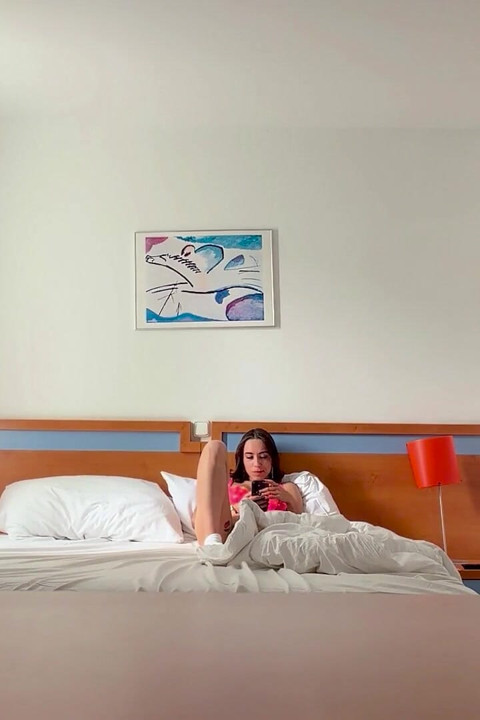Woman Being Recorded in Hotel Room