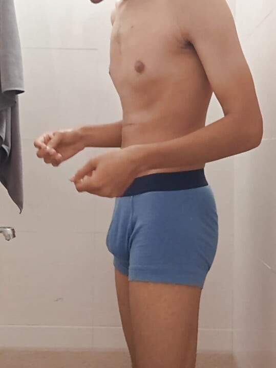 Teen indian boy taking shower