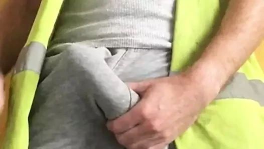 Tradesman uses hi vis vest as cumrag