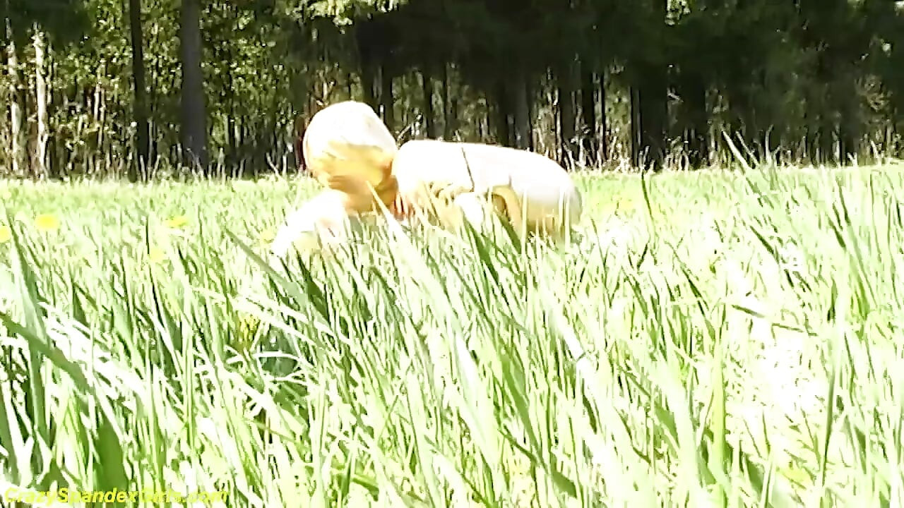 Sexy ebony babe in skintight golden spandex catsuit posing outdoor