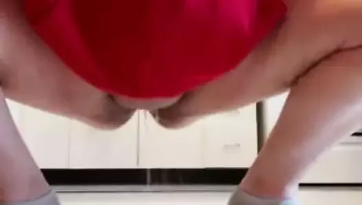 Girl pissing on the kitchen floor