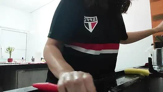Woman teasing while washing dishes. She loves to transmit to the voyeurs on duty