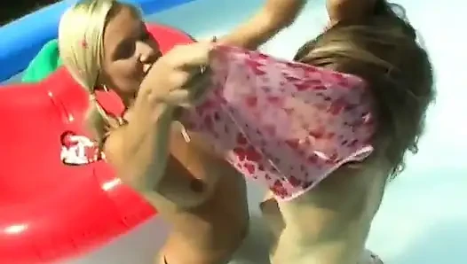 Lesbians have fun with a dildo at pool party