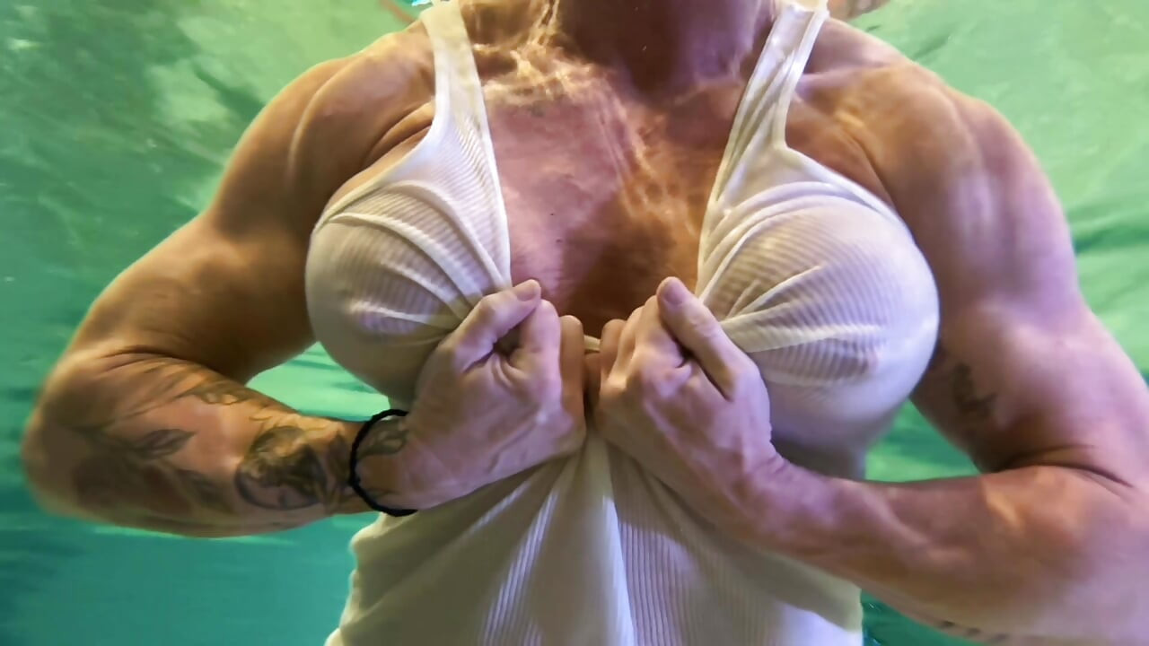 Amazon Kandy Flexes Her Massive Biceps in Her Hotel Pool