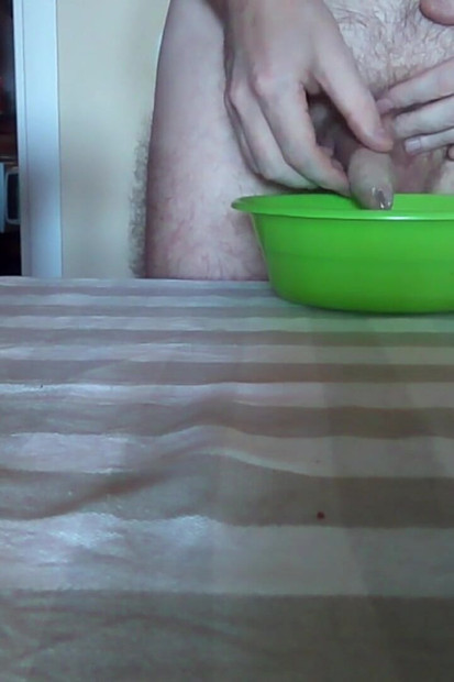 ジョンはテーブルの上の緑色のボウルにおしっこをしています