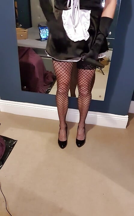 Being a good little sissy maid, all dressed up in her black satin French maid dress, fishnet stockings, 6 strap suspenders