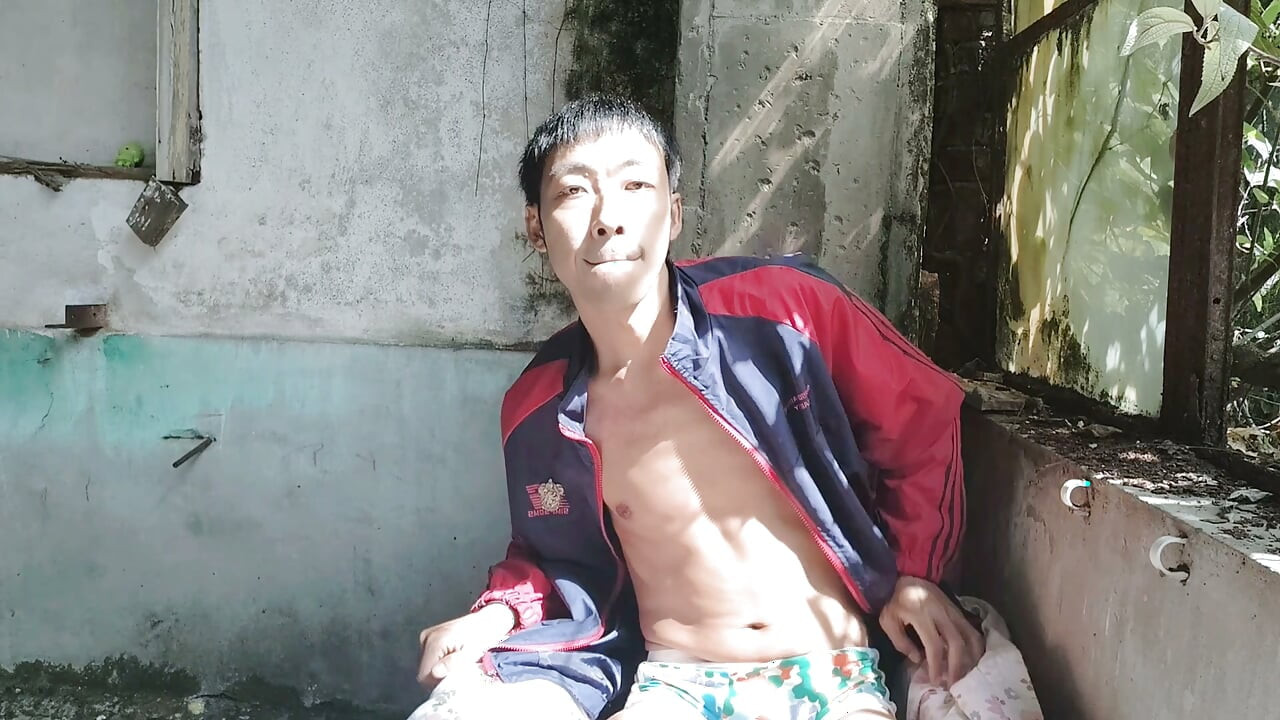 Super Asian boy lies in abandoned factory area, lying in sink, masturbating, ejaculating, moaning, and swallowing liquid