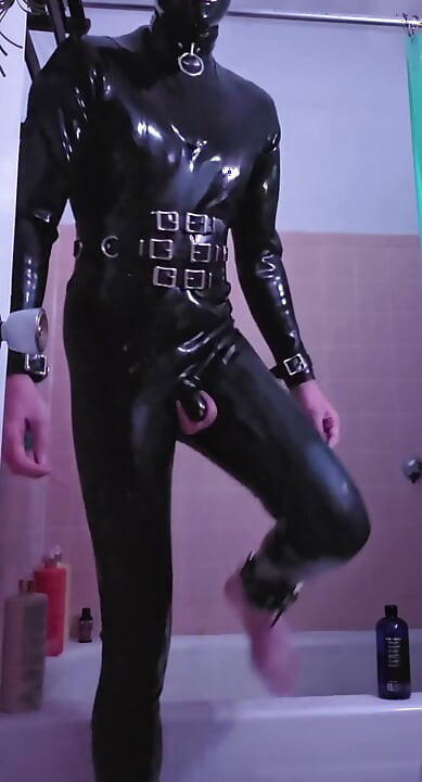 submissive rubber slave warms up it's ass and mouth before it's Master comes over