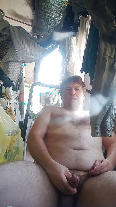 Guy jerks off on the deckchair cumming and evaluating his cum