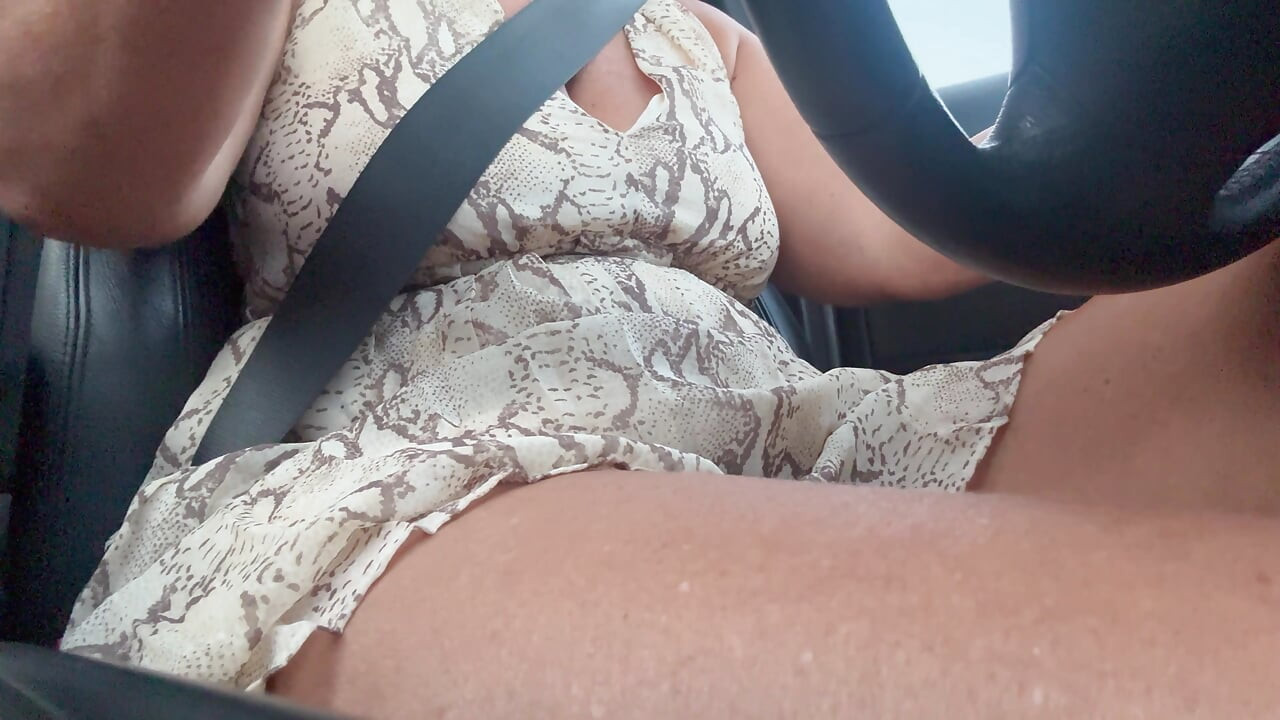 Elegant and sexy stepmom drives the car and rubs her pussy in the morning.