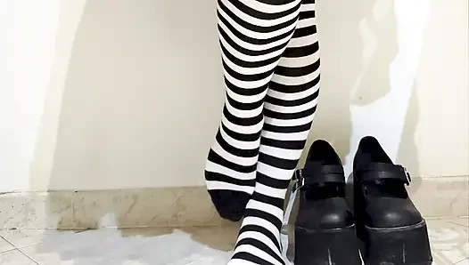 Goth crushing a banana under her shoes