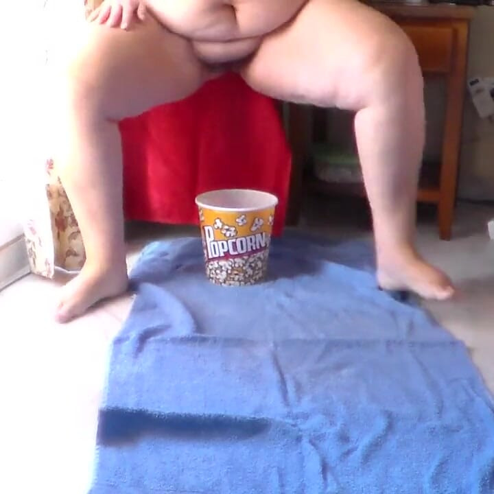 Jen is peeing into the popcorn bucket