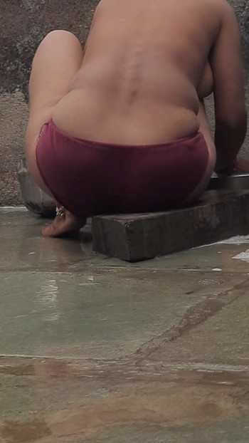 Unforgettable moment from "Desi Indian village bathroom in open courtyard wearing red tights bathing"